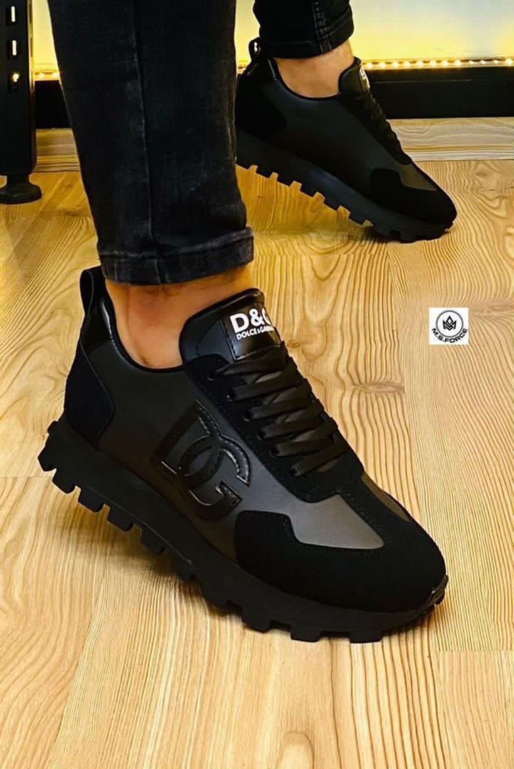 Black lace-up platform sneakers with tonal panels and a rugged sole