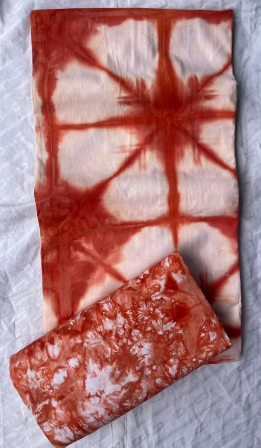 Five-yard coral red and cream tie-dye fabric with geometric and marbled patterns