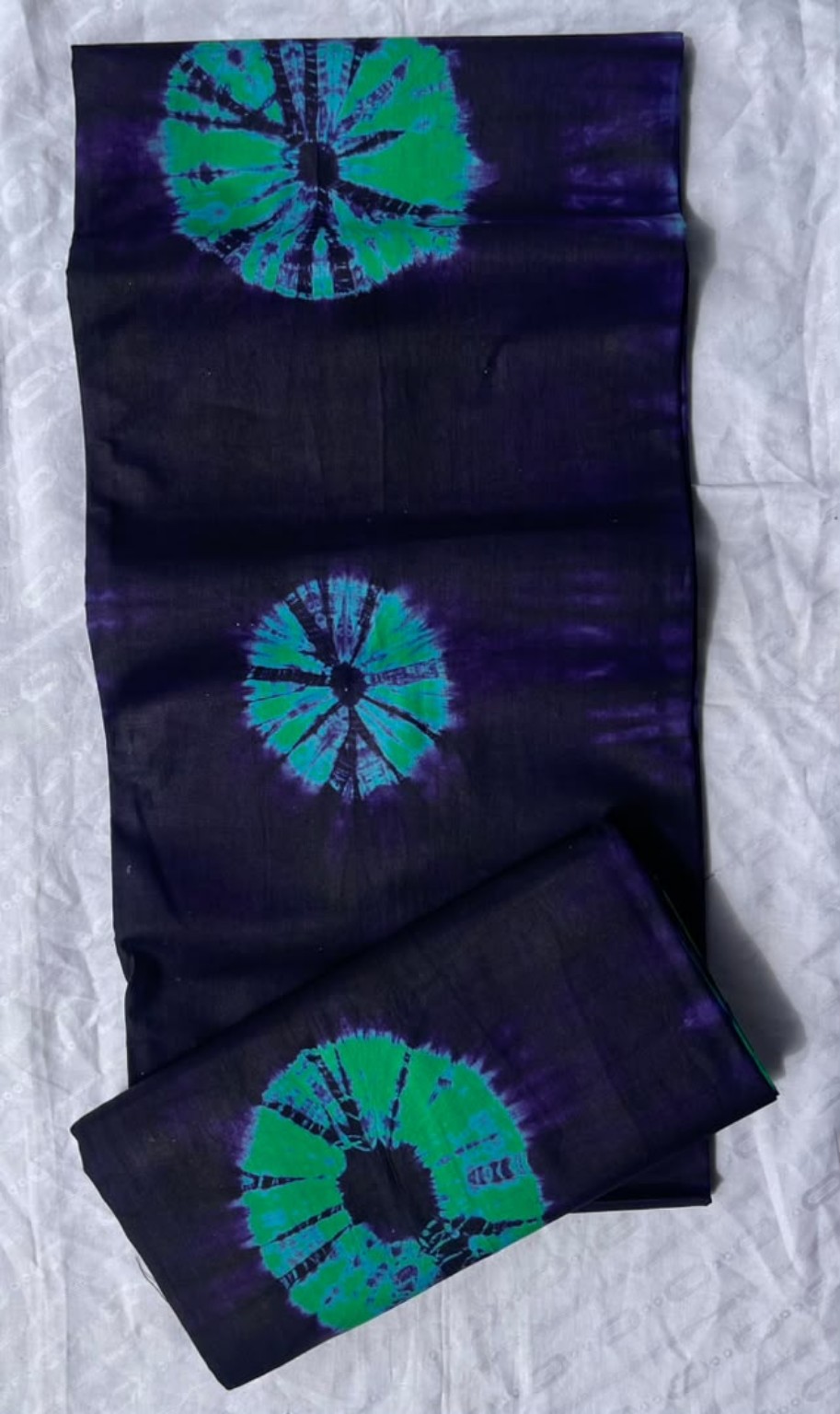 Five-yard midnight purple fabric with teal and green circular medallion motifs