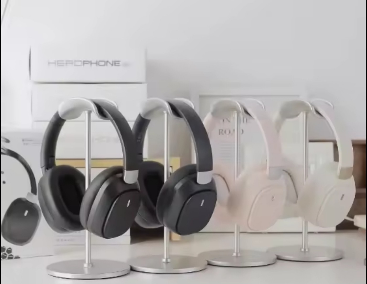 Black, white and beige over-ear wireless headphones displayed on stands